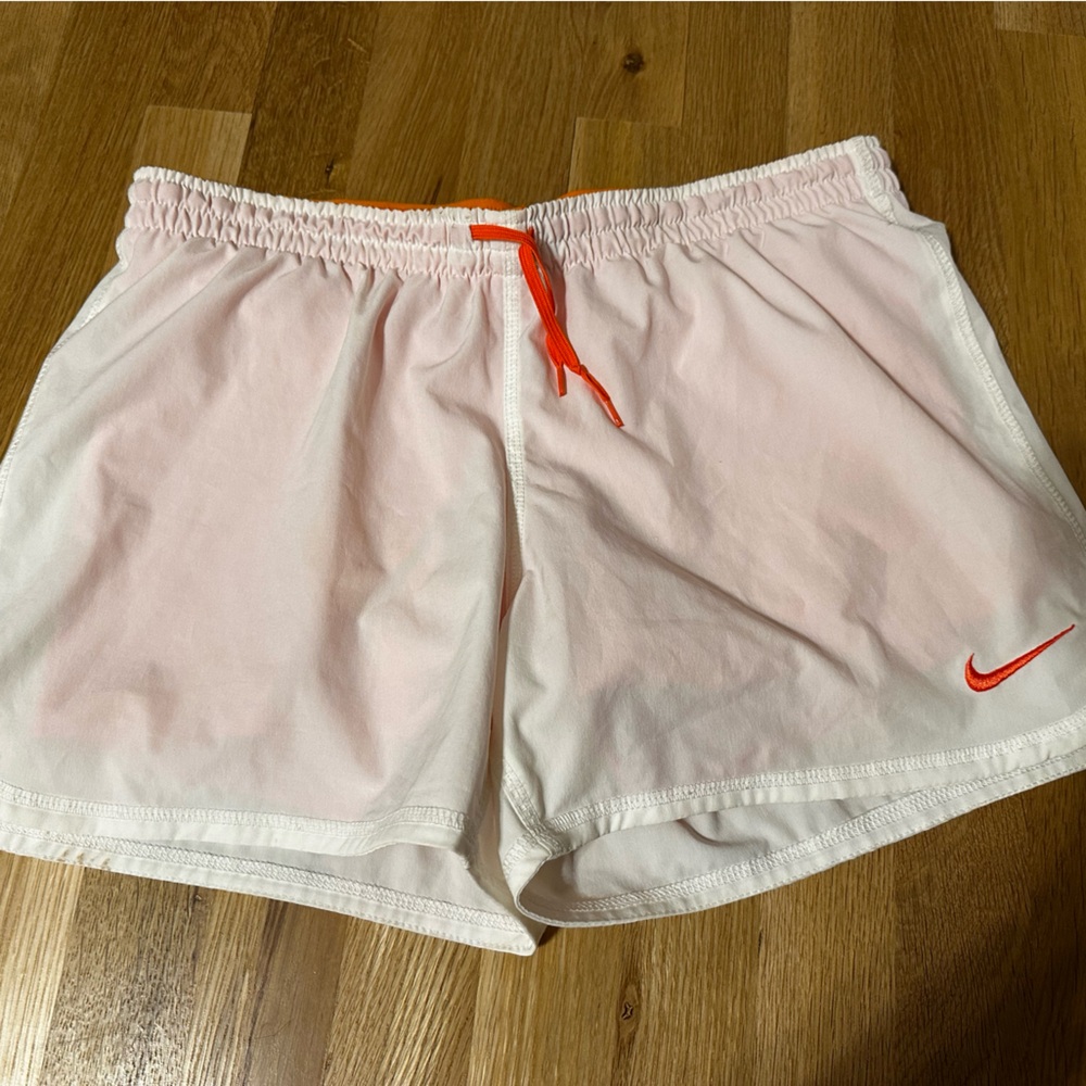 White Nike shorts with build in orange spandex, size Medium.